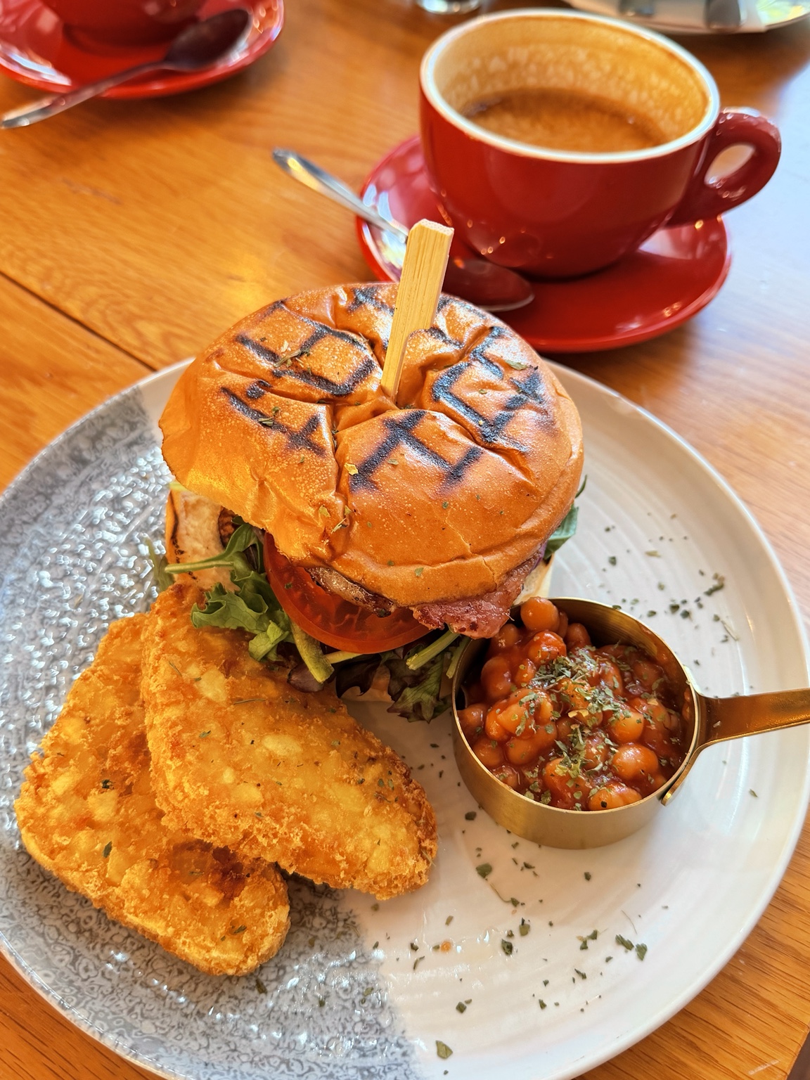 Burger plate with hash browns and baked beans